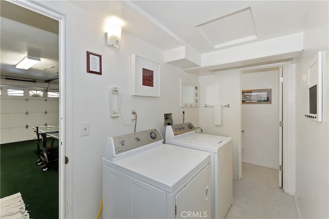 clothes washing area with washing machine and dryer