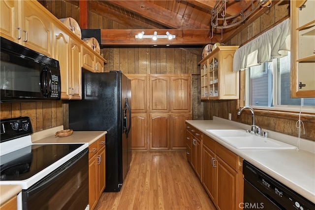 kitchen with wooden walls, sink, vaulted ceiling with beams, light hardwood / wood-style floors, and black appliances