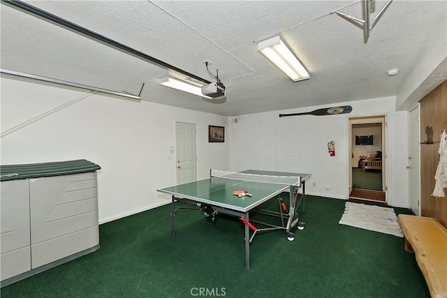 game room featuring a textured ceiling and carpet flooring