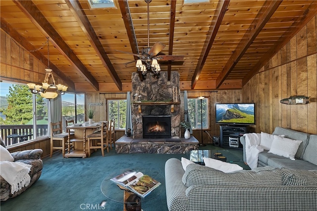 unfurnished living room featuring a stone fireplace, wooden walls, lofted ceiling with beams, and dark colored carpet