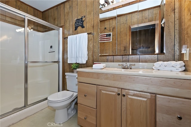 bathroom featuring vanity, toilet, wooden walls, and walk in shower