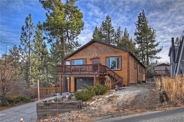 view of front of home featuring a wooden deck and a garage