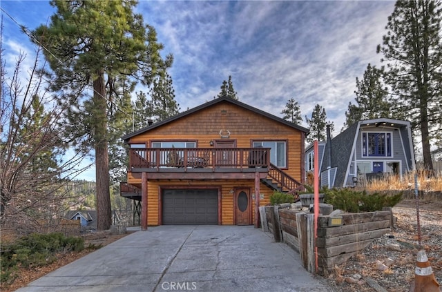 view of front of property with a wooden deck and a garage