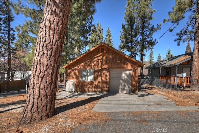 view of front of property with a garage and an outbuilding