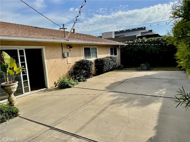 view of property exterior with a patio and stucco siding