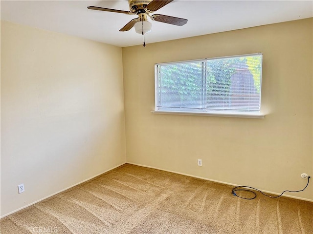 spare room featuring carpet floors and ceiling fan