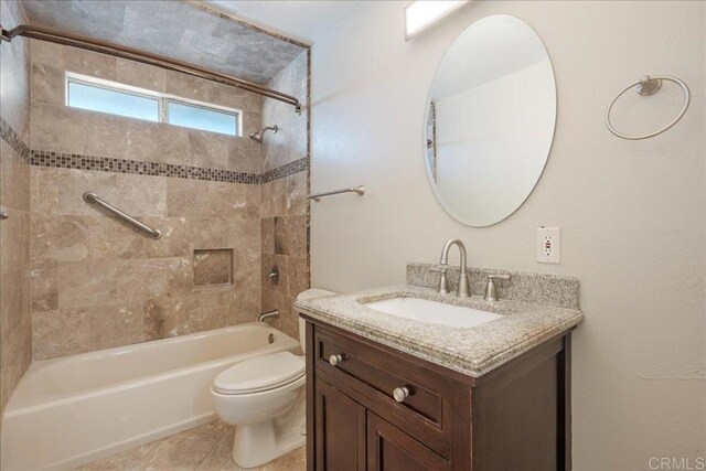 bathroom featuring tile patterned floors, shower / bathing tub combination, toilet, and vanity