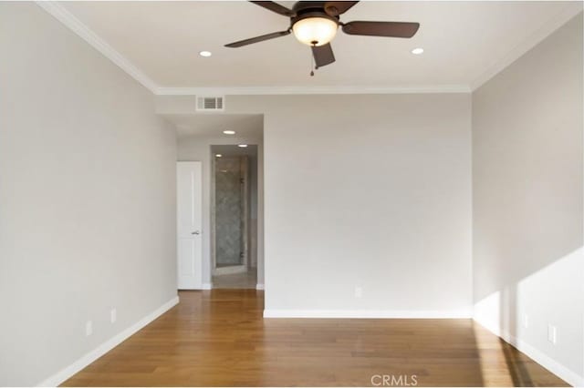 spare room featuring wood-type flooring, ornamental molding, and ceiling fan