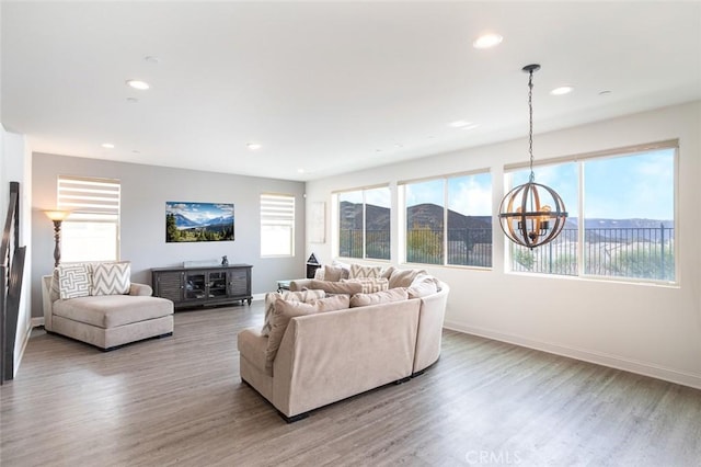 living room featuring light hardwood / wood-style flooring and a chandelier