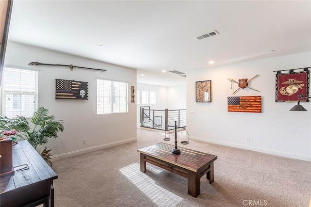 carpeted living room featuring plenty of natural light