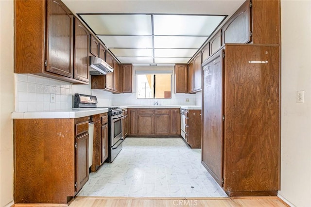 kitchen with tasteful backsplash and stainless steel range oven