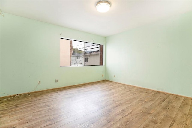 unfurnished room with light wood-type flooring