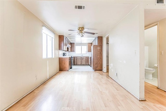 kitchen featuring electric stove, ceiling fan, and light hardwood / wood-style floors