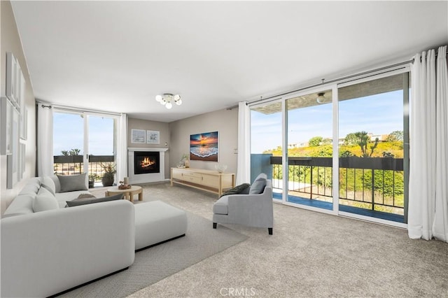 living room featuring floor to ceiling windows and light carpet