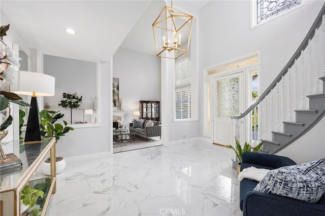 foyer entrance featuring marble finish floor, stairway, and baseboards