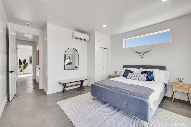 bedroom with a wall mounted air conditioner, concrete floors, and a closet