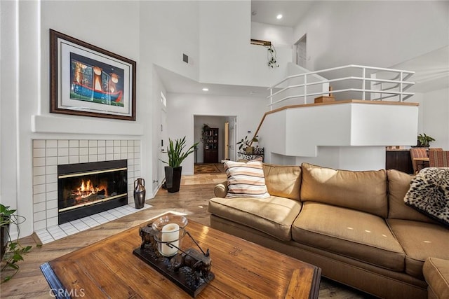 230 Shorebreaker Dr, Laguna Niguel, CA 92677 - living room with a tiled fireplace, wood-type flooring, and a high ceiling