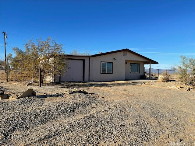 view of front of house featuring stucco siding