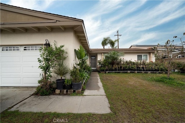 exterior space featuring a garage and a front lawn