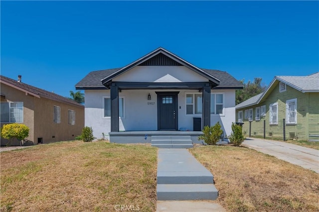 bungalow-style house featuring a porch and a front yard