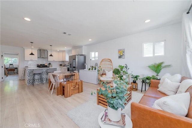 living room with plenty of natural light and light hardwood / wood-style floors