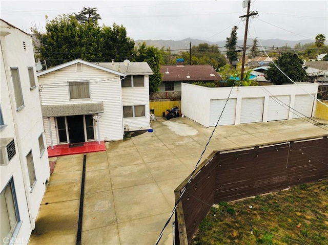 view of patio / terrace with a garage and an outdoor structure