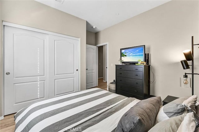 bedroom featuring light wood-type flooring and a closet