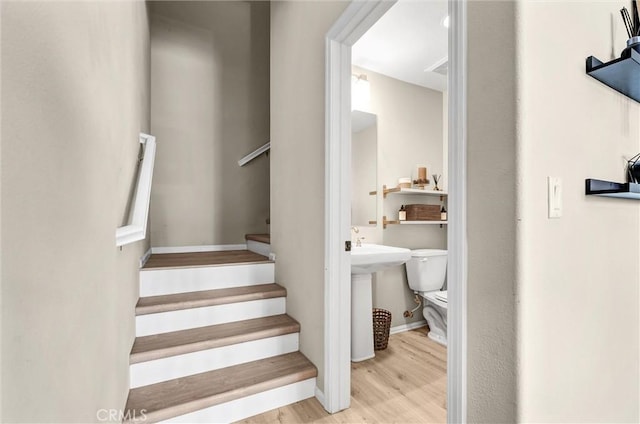 stairway with wood finished floors