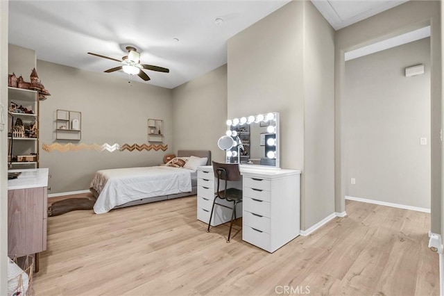 bedroom with light wood finished floors, a ceiling fan, and baseboards