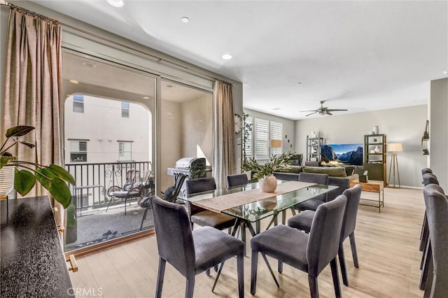 dining space with light wood-type flooring and a ceiling fan