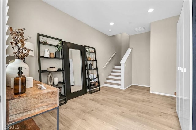 foyer featuring recessed lighting, visible vents, light wood-type flooring, baseboards, and stairs