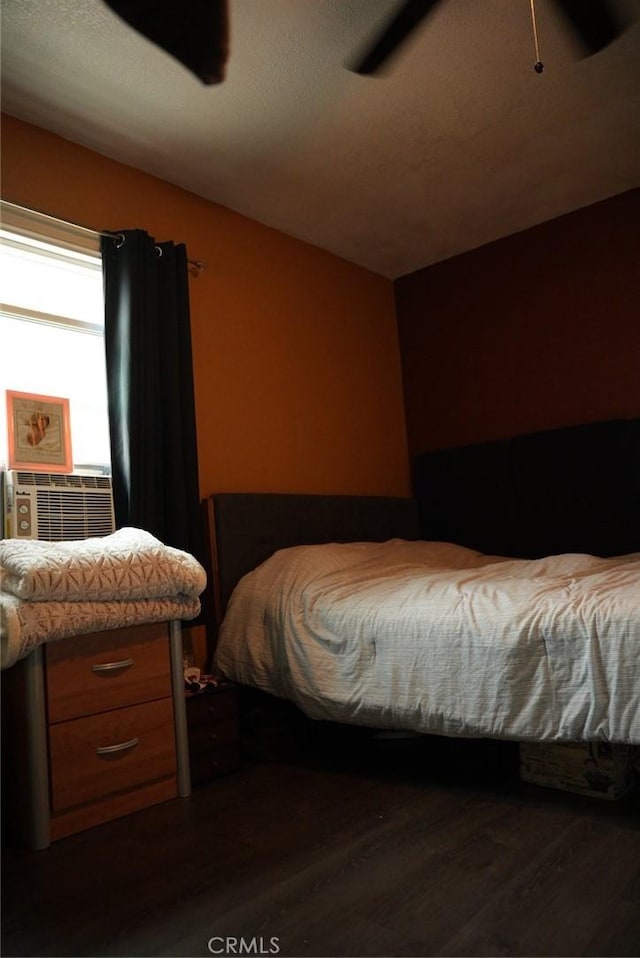 bedroom with vaulted ceiling, dark wood-type flooring, and cooling unit