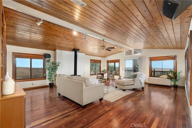 living room with wood ceiling, lofted ceiling, dark hardwood / wood-style flooring, and a wood stove