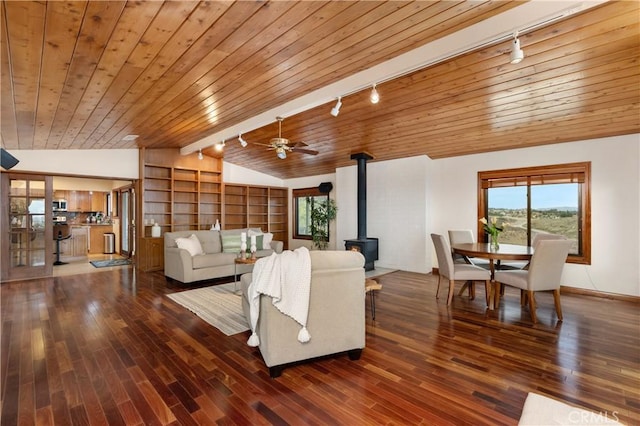 living room with wooden ceiling, lofted ceiling, dark hardwood / wood-style flooring, and a wood stove