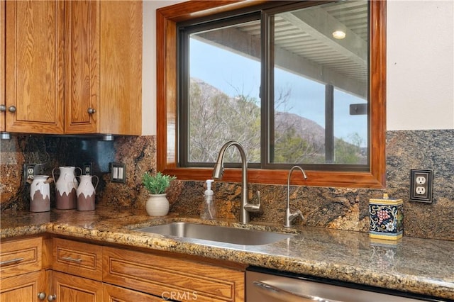 kitchen with sink, dishwasher, stone counters, tasteful backsplash, and a mountain view