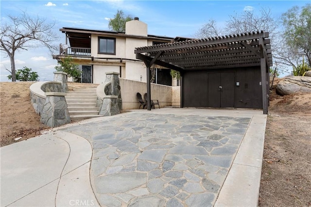 back of house featuring a pergola