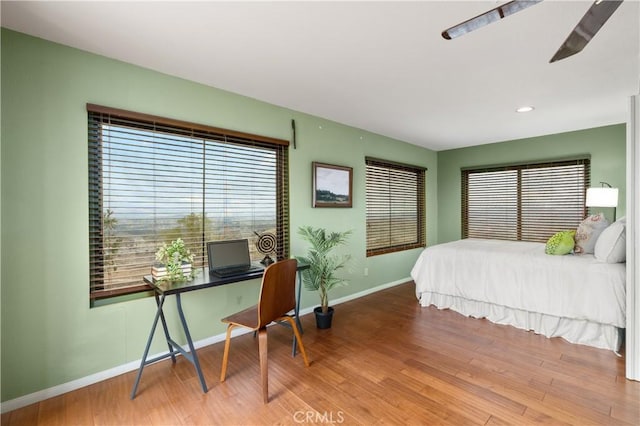 bedroom with ceiling fan and wood-type flooring