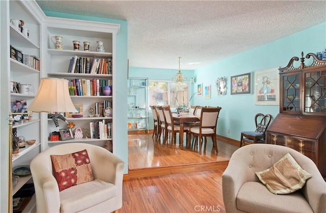 sitting room featuring a textured ceiling and light hardwood / wood-style floors