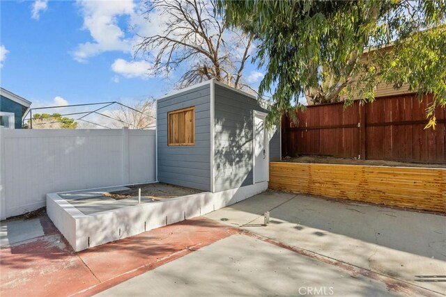 view of outbuilding with a patio area