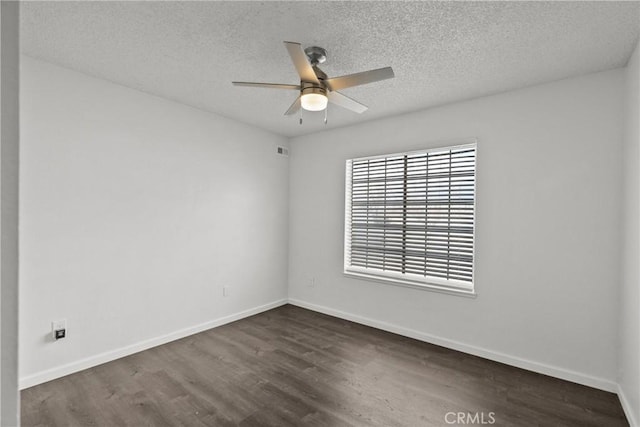 unfurnished room with a textured ceiling, dark wood-type flooring, and ceiling fan