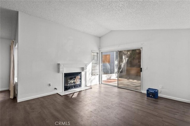 unfurnished living room featuring vaulted ceiling, a textured ceiling, and dark hardwood / wood-style flooring