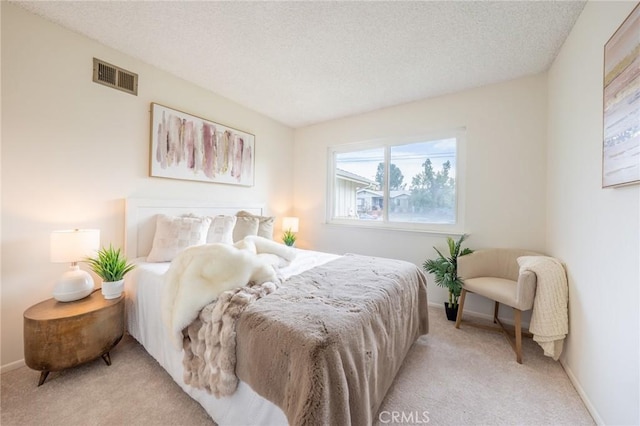 carpeted bedroom with a textured ceiling