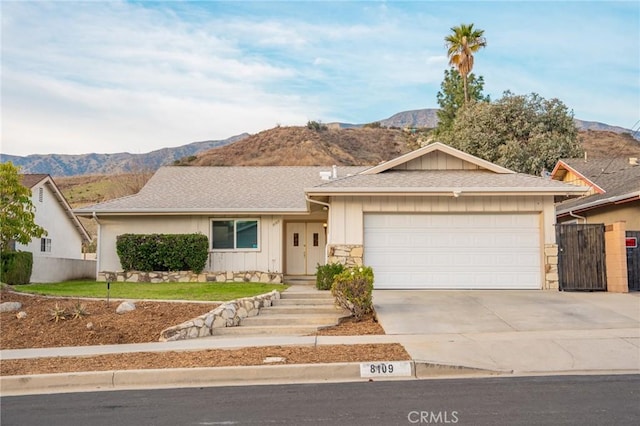 ranch-style house with a mountain view and a garage