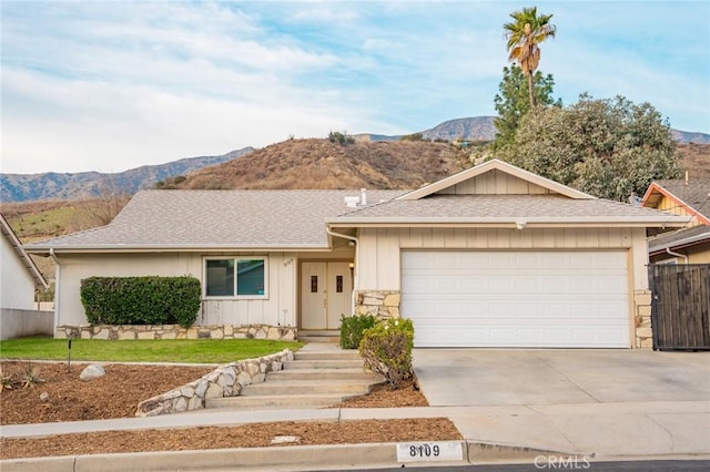 single story home featuring a mountain view and a garage