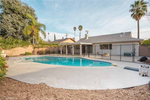 view of swimming pool with a patio and central air condition unit