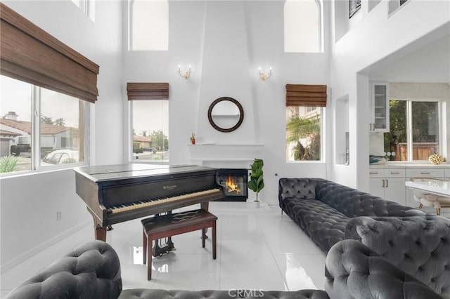 living room featuring a towering ceiling and a wealth of natural light