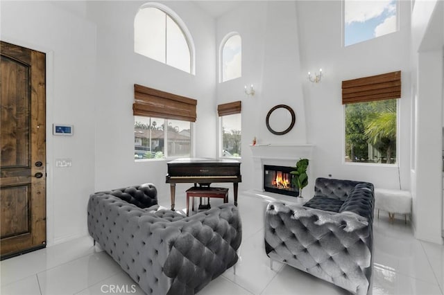 tiled living room featuring a towering ceiling