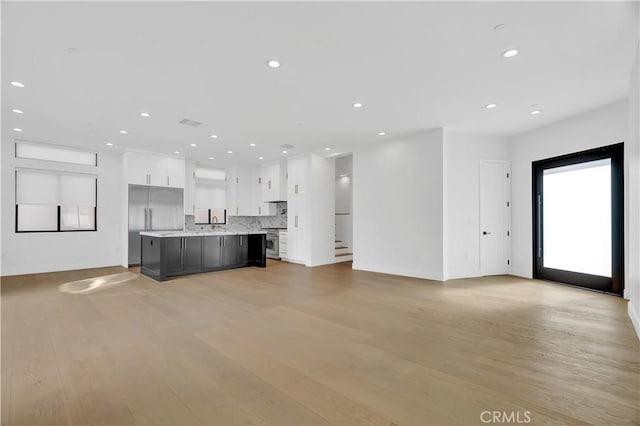 2319 Huntington Ln Unit A, Redondo Beach, CA 90278 - unfurnished living room featuring recessed lighting, light wood-type flooring, and stairs