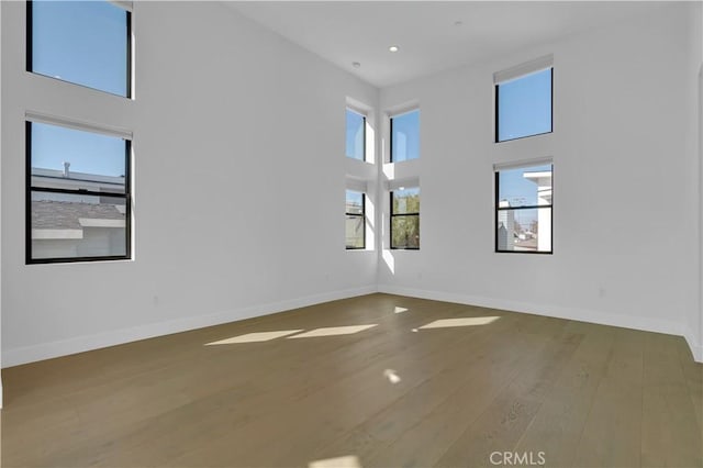 2319 Huntington Ln Unit A, Redondo Beach, CA 90278 - spare room featuring wood finished floors, a high ceiling, and recessed lighting