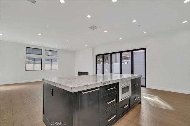 2319 Huntington Ln Unit A, Redondo Beach, CA 90278 - kitchen featuring built in microwave, light wood finished floors, a kitchen island, plenty of natural light, and recessed lighting